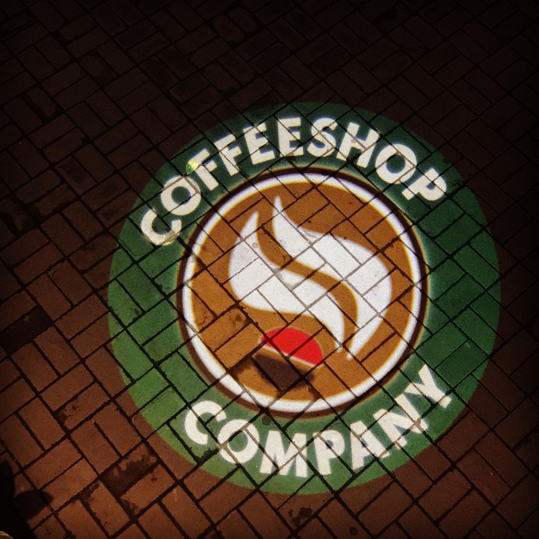 Coffeeshop logo projected on sidewalk by One Gobo projector.