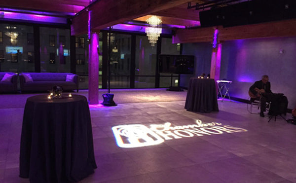 Event floor illuminated with bold logo projection by One Gobo.
