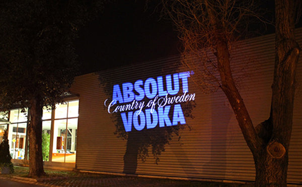 Absolut Vodka logo vividly projected on building exterior by One Gobo projector.